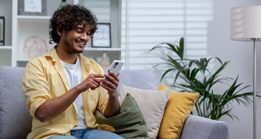 Resident navigating a home security app on his mobile device